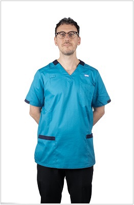 A photo of a healthcare scientist wearing a uniform in peacock with navy contrast trim.