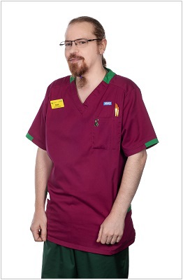 A photo of a music, art and drama therapist wearing a uniform in ruby with dark green trim.