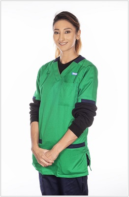 A photo of a pharmacy technician wearing a uniform in Sherwood green with navy contrast trim.