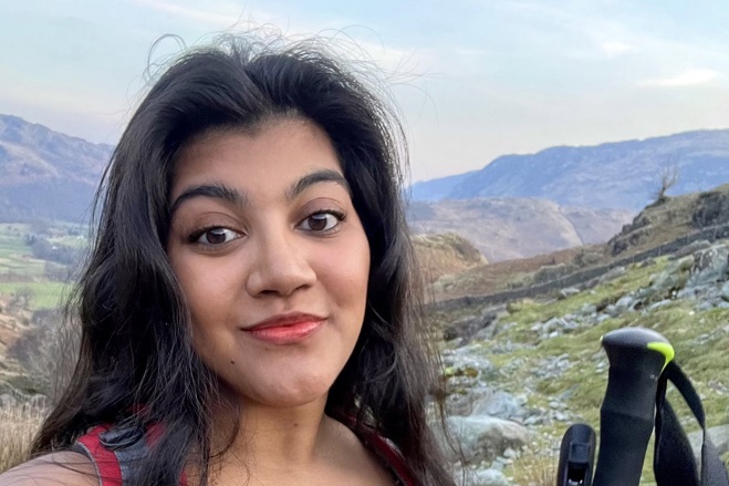 A photo of Christie patient Demisha Patel standing on a hill.