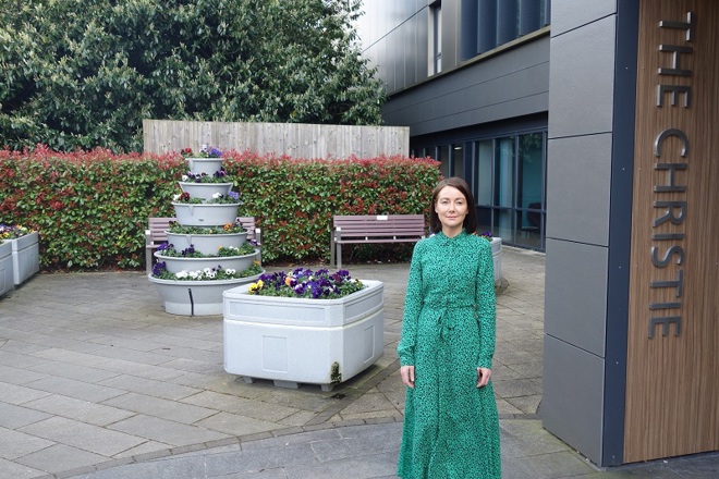 A photo of Christie patient Sarah on her first day of treatment outside The Christie proton beam therapy centre.