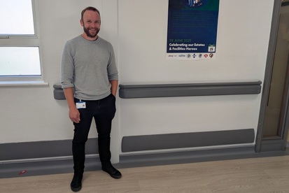 A photo of Christie waste minimisation officer Tom Spencer standing on a corridor.