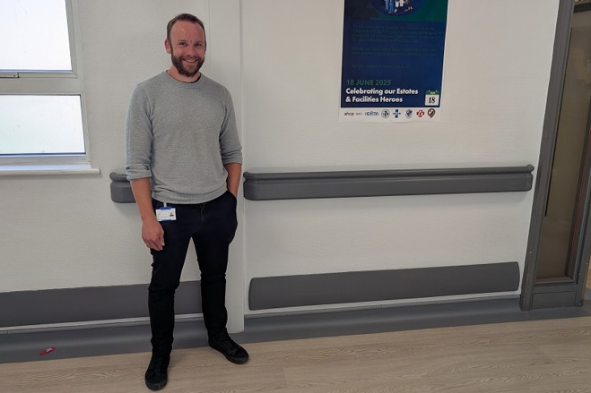 A photo of Christie waste minimisation officer Tom Spencer standing on a corridor.