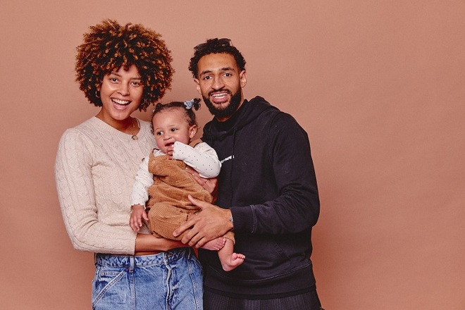 A photo of Christie patient Paige with her partner Deano and their baby.