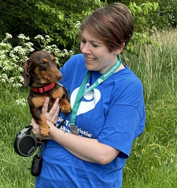 A photo of Christie patient and fundraiser Kat Watson-Wood holding a dog.