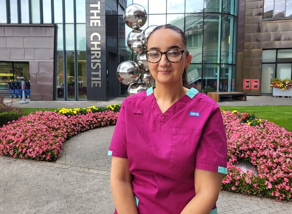 A photo of Christie radiographer Suzanne Lagan standing outside the main entrance to The Christie.
