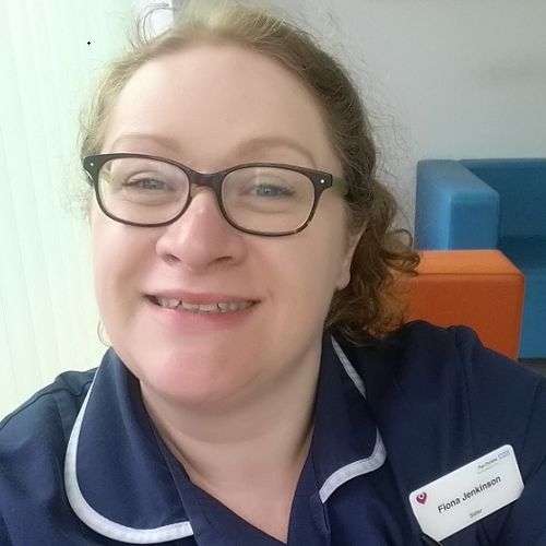 A photo of Fiona Jenkinson, nurse and chaplain at The Christie. She is wearing her nursing uniform and a name badge reading 'Fiona Jenkinson, Sister'.