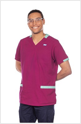 A photo of a diagnostic radiographer wearing a uniform in ruby with pale green trim.