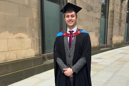 A photo of Kane Wildman in a graduation cap and gown.