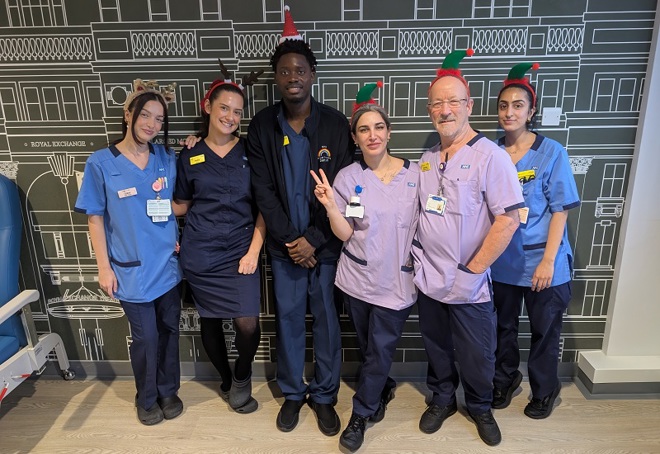 A photo of Grace Garbett and India Hallgate, and the rest of the ward 12 team at The Christie wearing Christmas headbands.