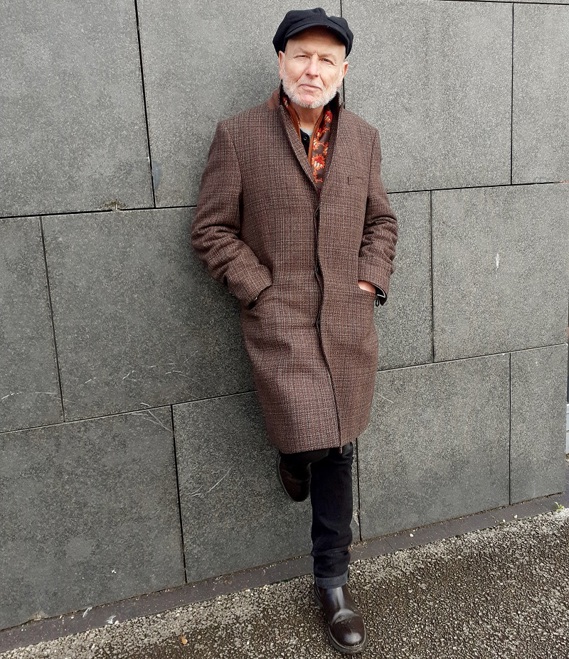 A photo of Graham Caveney, author and journalist from Accrington and Christie patient, leaning against a wall.