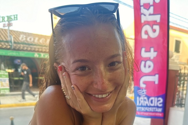 A photo of Christie patient Claudia Laird wearing sunglasses on top of her head.