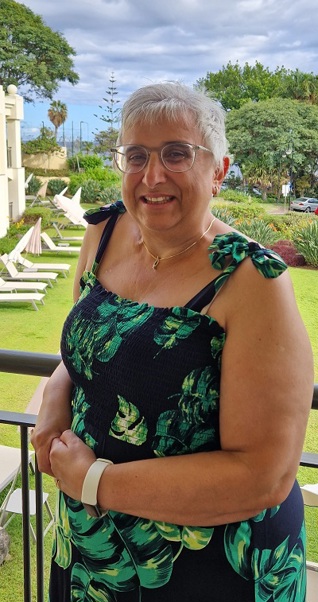 A photo of Christie patient Liz Bates standing in a garden.