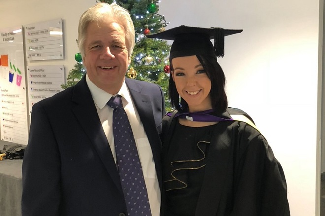 A photo of Sarah with her dad David at her graduation.
