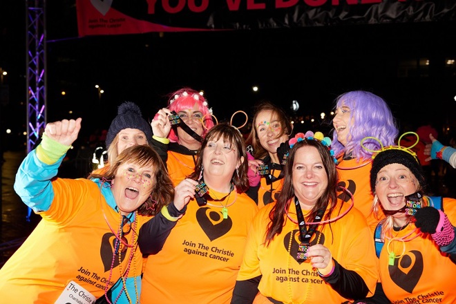 A photo of a group of women showing medals to the camera at The Christie Charity Night of Neon event.