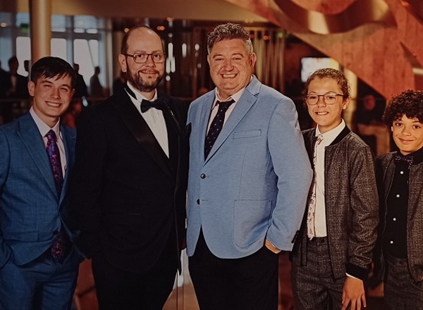 A photo of Christie patient David Jones-Stanley, his husband James and their 3 sons.