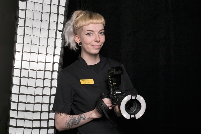A photo of Georgia Woodcock, a medical photographer at The Christie holding a camera.