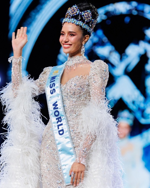 A photo of Miss World 2025 Opal Suchata Chuangsri wearing a sash and crown, and waving.