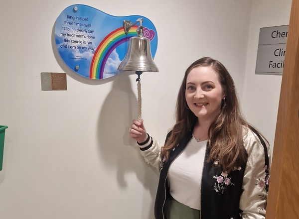 A photo of Christie patient Zara McCormick ringing the end-of-treatment bell.