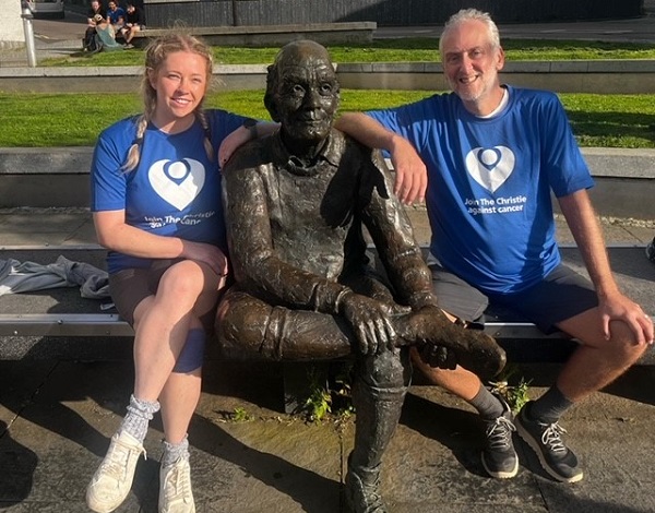 A photo of Christie fundraiser Courtney Dobson sitting on a bench with her dad, Darren Walker and a statue.