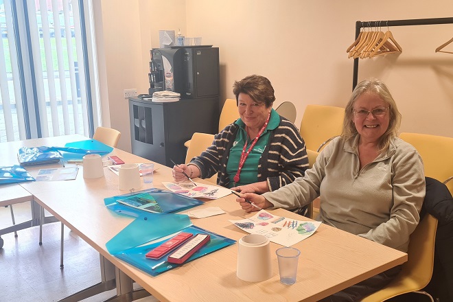 A photo of Christie patient Michelle Hardiman with a staff member at an art class.