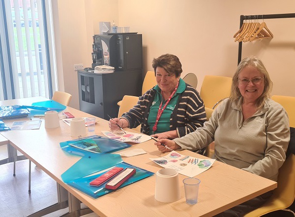 A photo of Christie patient Michelle Hardiman with a staff member at an art class.