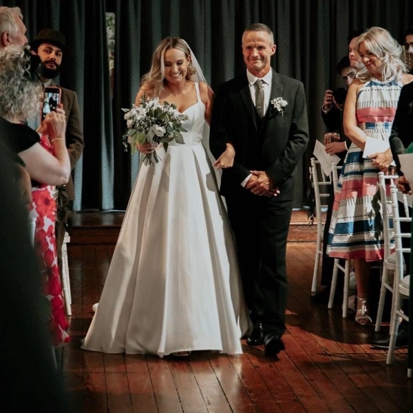 A photo of Christie patient Tex Leece walking his daughter Holly down the aisle at her wedding.
