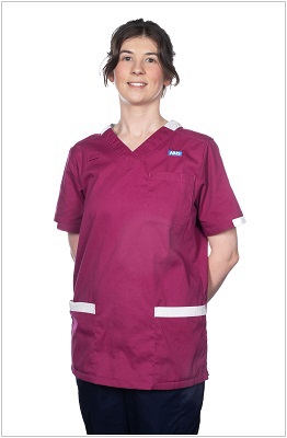A photo of a therapeutic radiographer wearing a uniform in ruby with white trim.