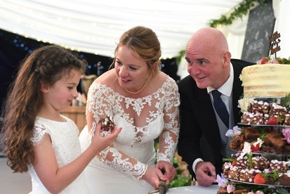 A photo of Gemma and Gary Knowles with their daughter on their wedding day.