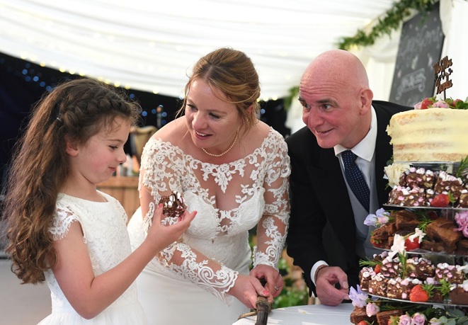 A photo of Gemma and Gary Knowles with their daughter on their wedding day.