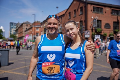 A photo of Christie fundraisers Jonny and Holly Crebbin wearing Christie running tanks tops at the Great Manchester Run.